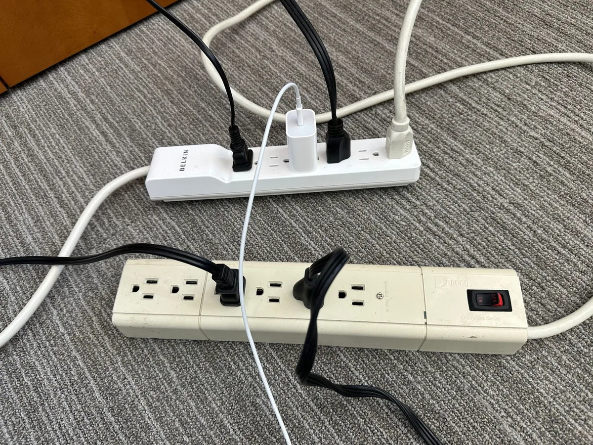 floor lamp is plugged into daisy-chained power strips